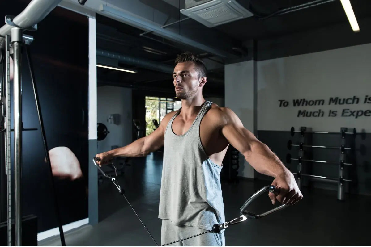 élévations latérales poulie épaule dans une salle de musculation